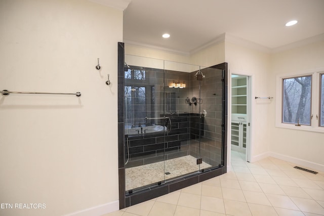 bathroom featuring crown molding, a shower with shower door, and tile patterned flooring