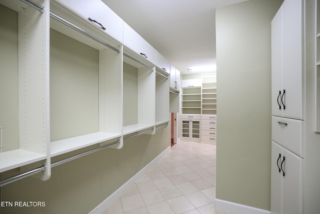 walk in closet featuring light tile patterned flooring