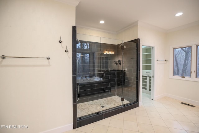 bathroom with crown molding, tile patterned floors, and walk in shower