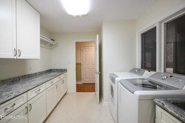 laundry room with cabinets and washer and dryer