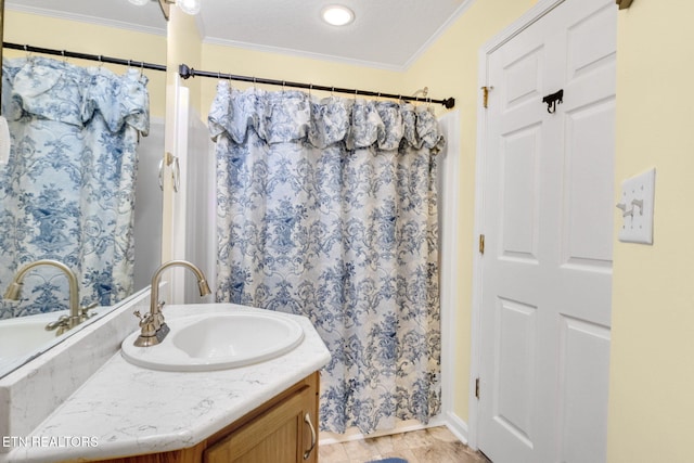 bathroom featuring vanity, a textured ceiling, curtained shower, and ornamental molding