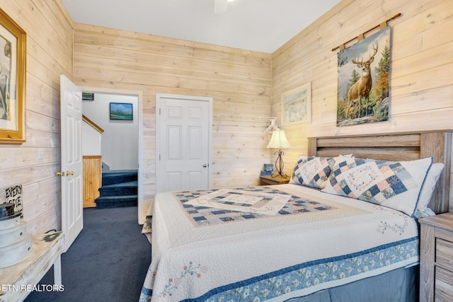 carpeted bedroom with wooden walls