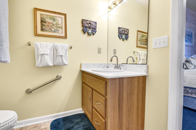 bathroom with tile patterned flooring, vanity, and toilet