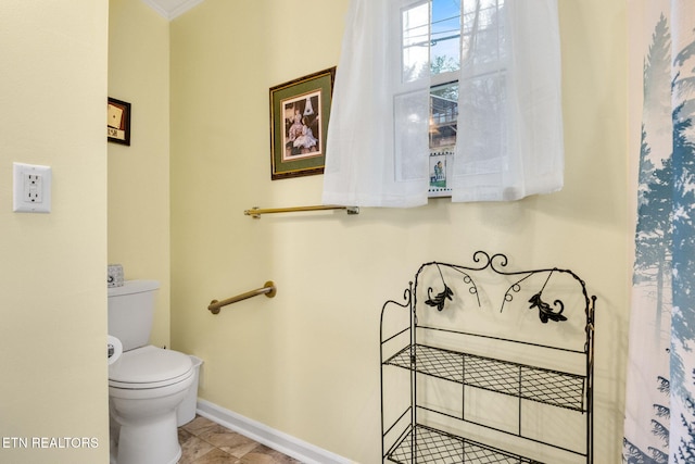 bathroom featuring tile patterned flooring and toilet