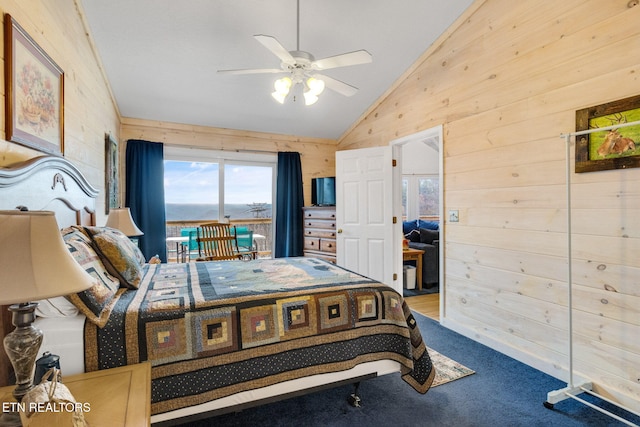 bedroom featuring ceiling fan, wood walls, carpet, and lofted ceiling