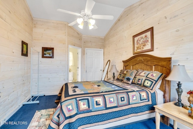 carpeted bedroom with ceiling fan, wood walls, and vaulted ceiling