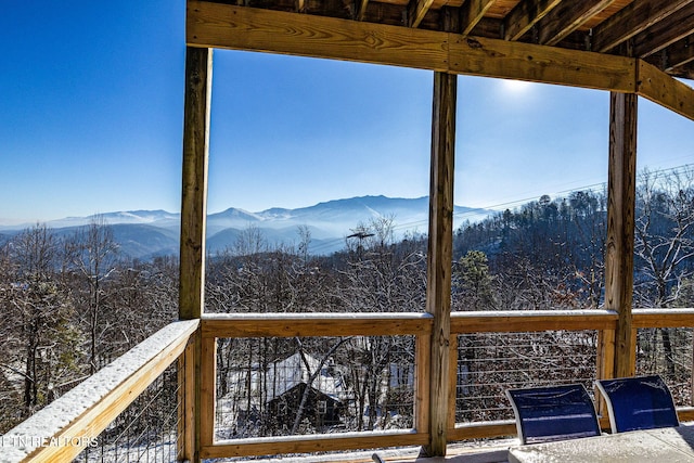 snow covered deck featuring a mountain view