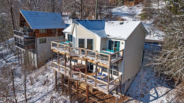 snow covered property with a wooden deck