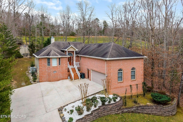 view of front of house featuring cooling unit and a garage