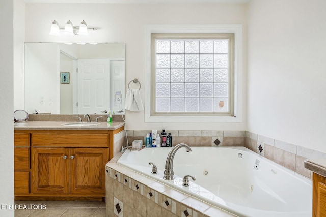 bathroom featuring tile patterned floors, tiled tub, and vanity