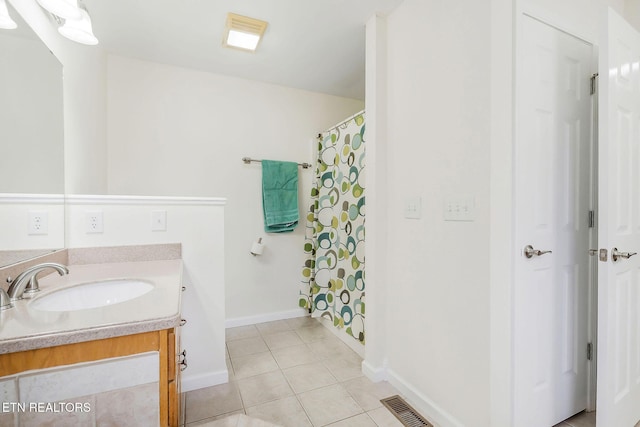 bathroom with tile patterned floors and vanity