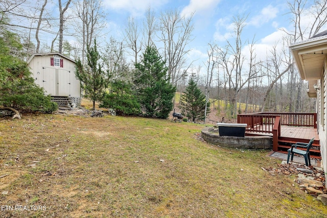 view of yard with a storage shed and a deck