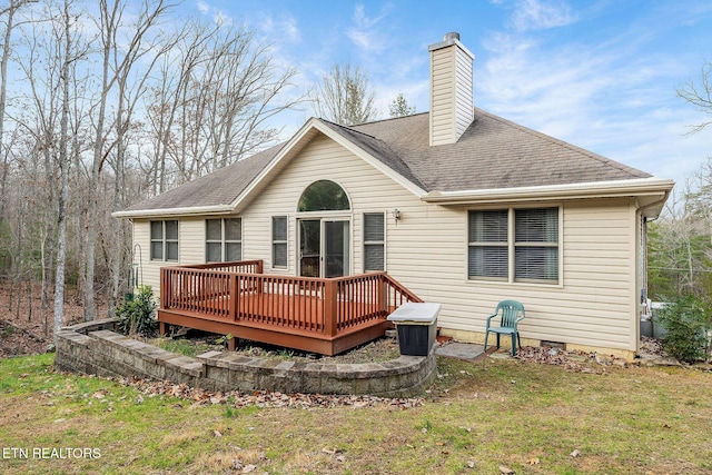 back of house with a lawn and a wooden deck