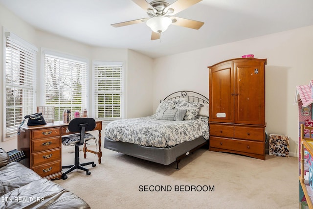 carpeted bedroom featuring ceiling fan