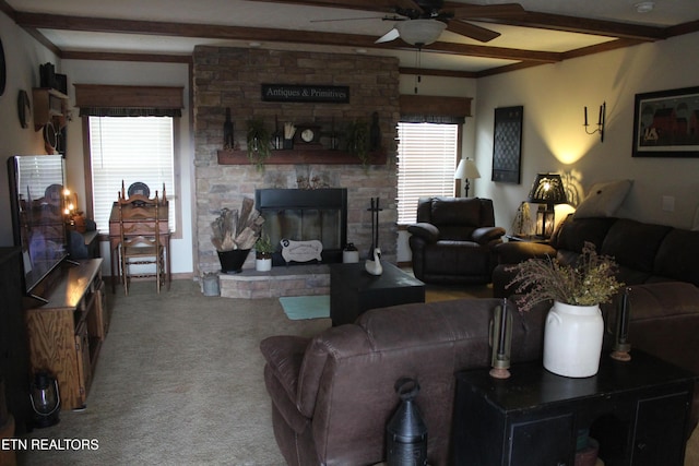 living room with carpet flooring, ceiling fan, a fireplace, plenty of natural light, and beam ceiling