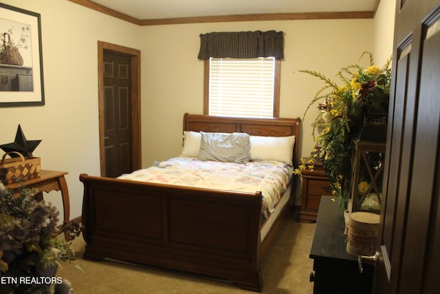 carpeted bedroom featuring crown molding