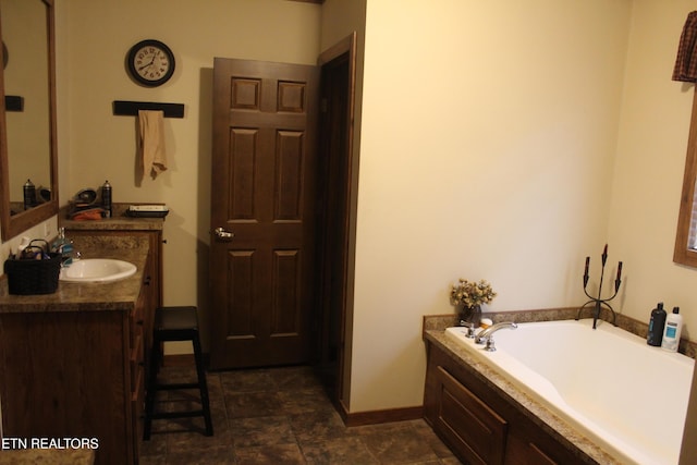 bathroom featuring vanity and a tub