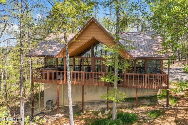 back of property featuring cooling unit and a wooden deck