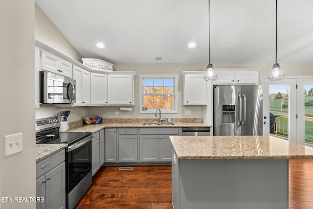 kitchen with dark hardwood / wood-style flooring, sink, pendant lighting, and appliances with stainless steel finishes