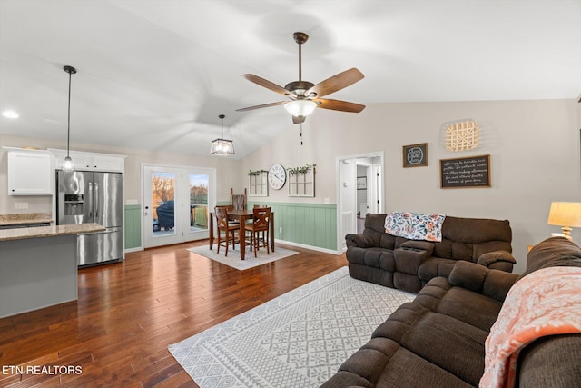 living room featuring ceiling fan, dark wood-type flooring, and lofted ceiling