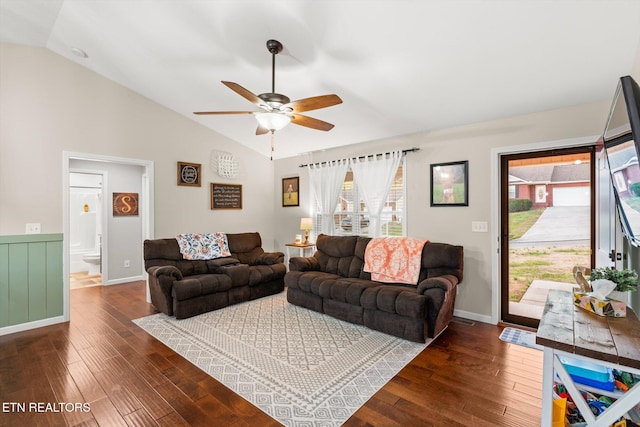 living room with vaulted ceiling, ceiling fan, and dark wood-type flooring