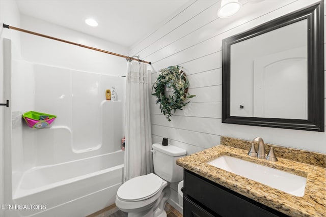 full bathroom with toilet, vanity, shower / tub combo with curtain, and wood walls