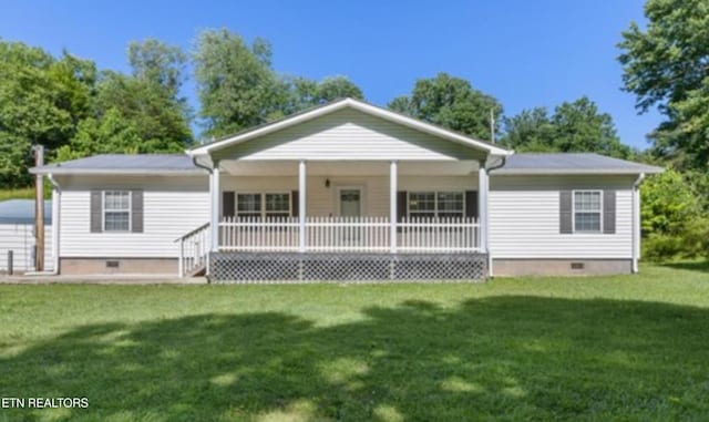 back of property with covered porch and a yard