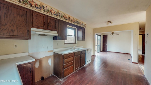 kitchen featuring dark brown cabinetry, ceiling fan, dishwasher, sink, and dark hardwood / wood-style flooring