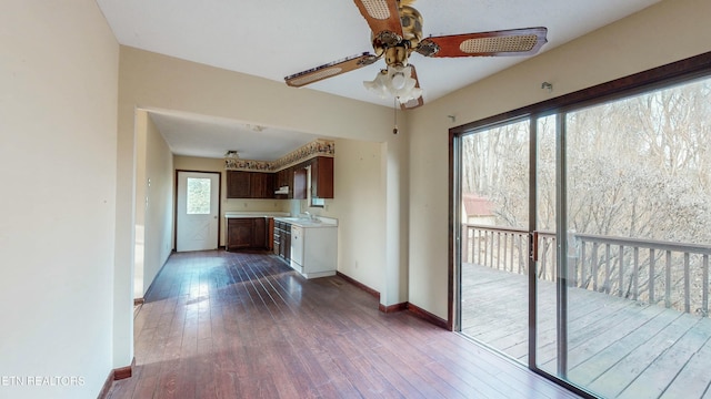 kitchen featuring ceiling fan, sink, and dark wood-type flooring