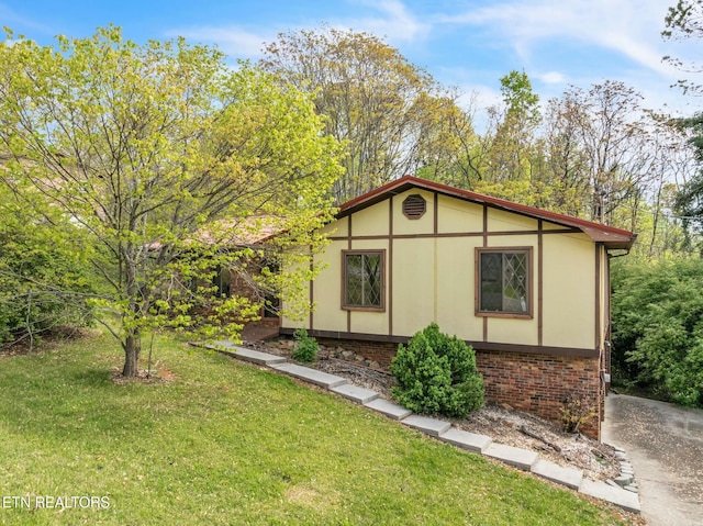 view of home's exterior featuring a lawn and stucco siding