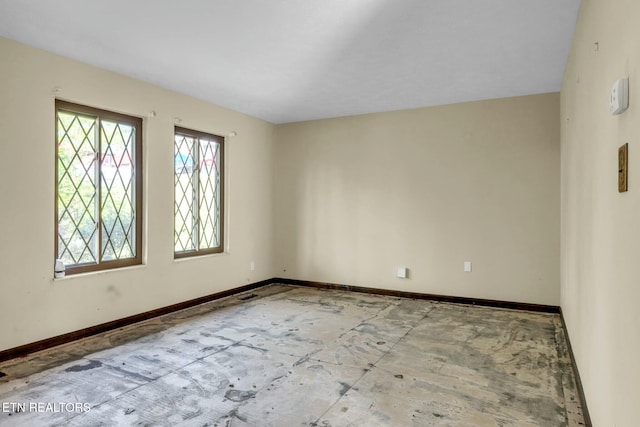 unfurnished room with visible vents and baseboards