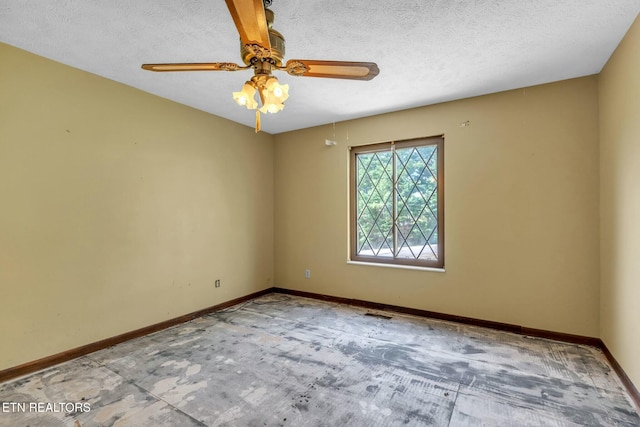 spare room featuring a textured ceiling, baseboards, and ceiling fan