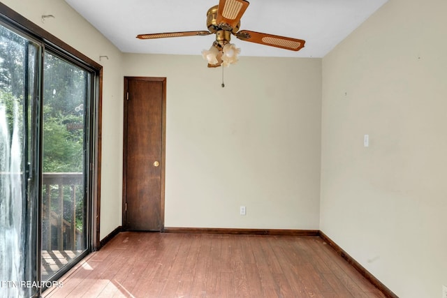 empty room featuring baseboards, a wealth of natural light, and light wood-style floors