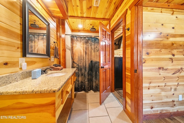 bathroom with vanity, tile patterned floors, wood walls, and wood ceiling