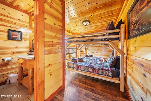 bedroom with wooden walls and wooden ceiling