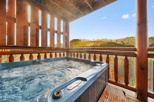 wooden terrace featuring a hot tub