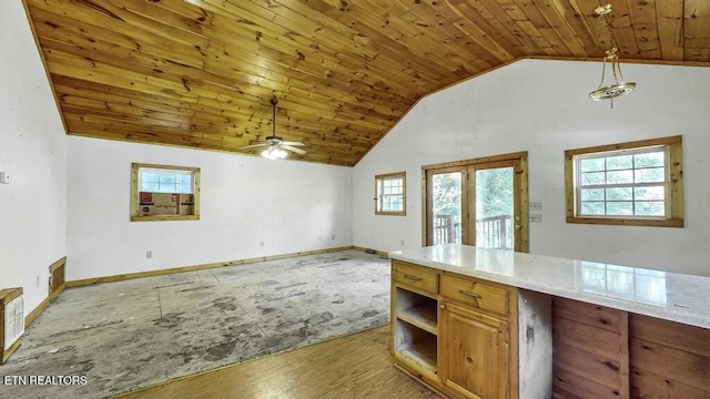 kitchen with lofted ceiling, wooden ceiling, french doors, hanging light fixtures, and ceiling fan