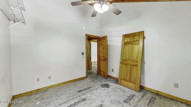 unfurnished room featuring a towering ceiling and ceiling fan