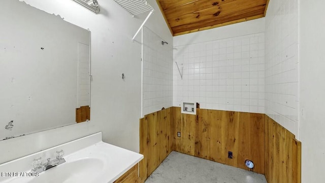 bathroom with wooden walls, vanity, and wood ceiling