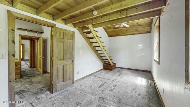 empty room featuring beamed ceiling and wooden ceiling