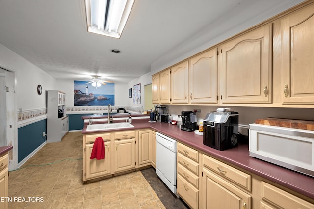 kitchen featuring white appliances, sink, ceiling fan, light brown cabinetry, and kitchen peninsula