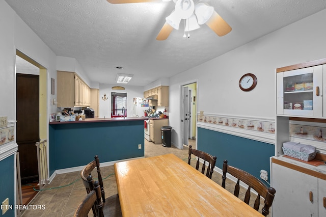 dining room with ceiling fan and a textured ceiling