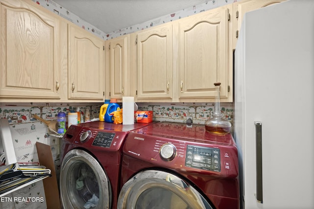 laundry area featuring cabinets and washing machine and dryer