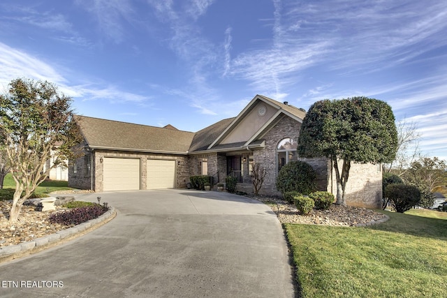 view of front of house with a front yard and a garage