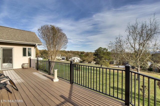 wooden deck featuring a yard