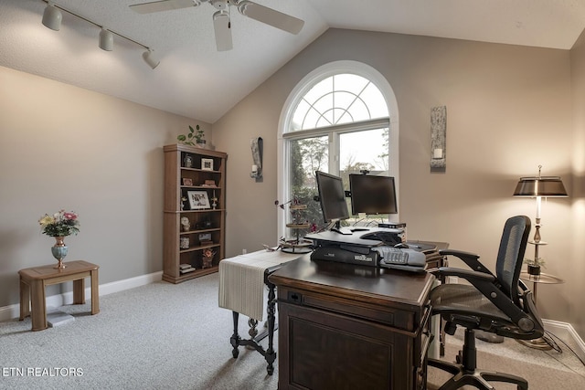 home office featuring ceiling fan, light colored carpet, track lighting, and vaulted ceiling