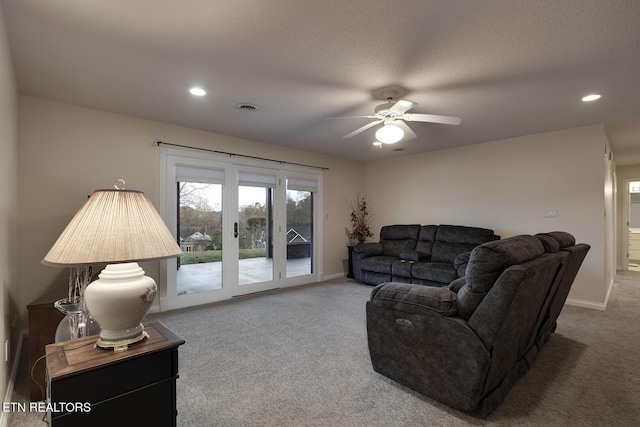 carpeted living room with ceiling fan and french doors