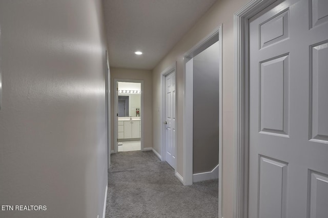 hallway featuring light carpet