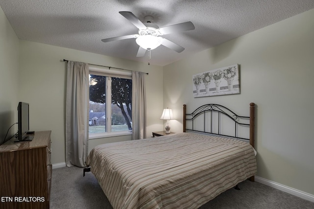 carpeted bedroom featuring ceiling fan and a textured ceiling