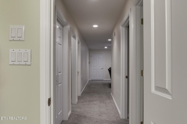 hallway featuring light colored carpet